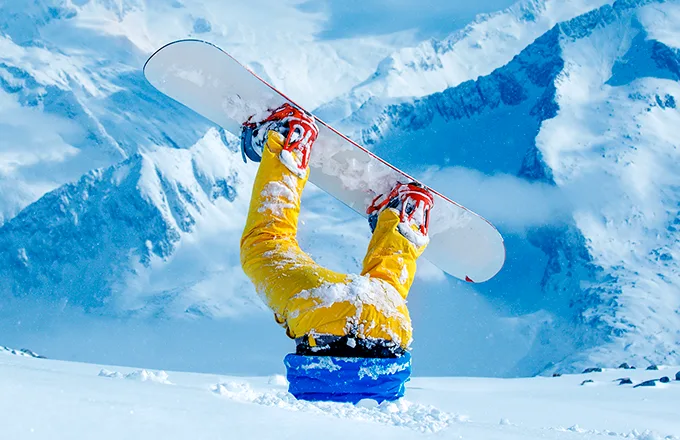 snowboarder upside down in snow