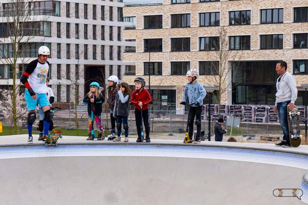 older skateboarder and kids in a skate park