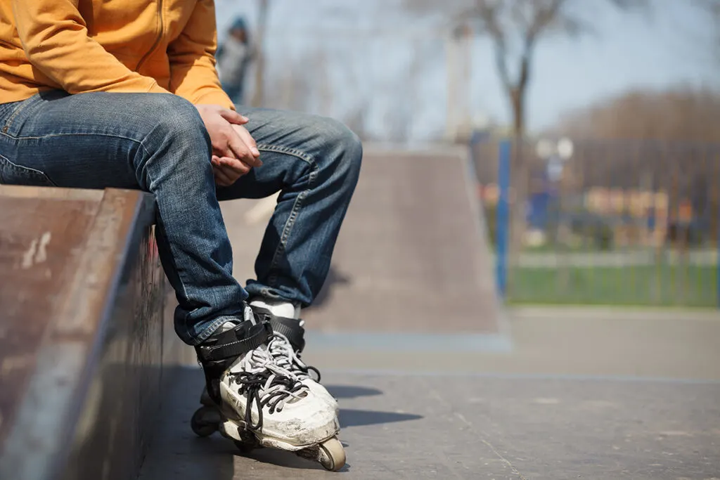 rollerblader sitting on a bank